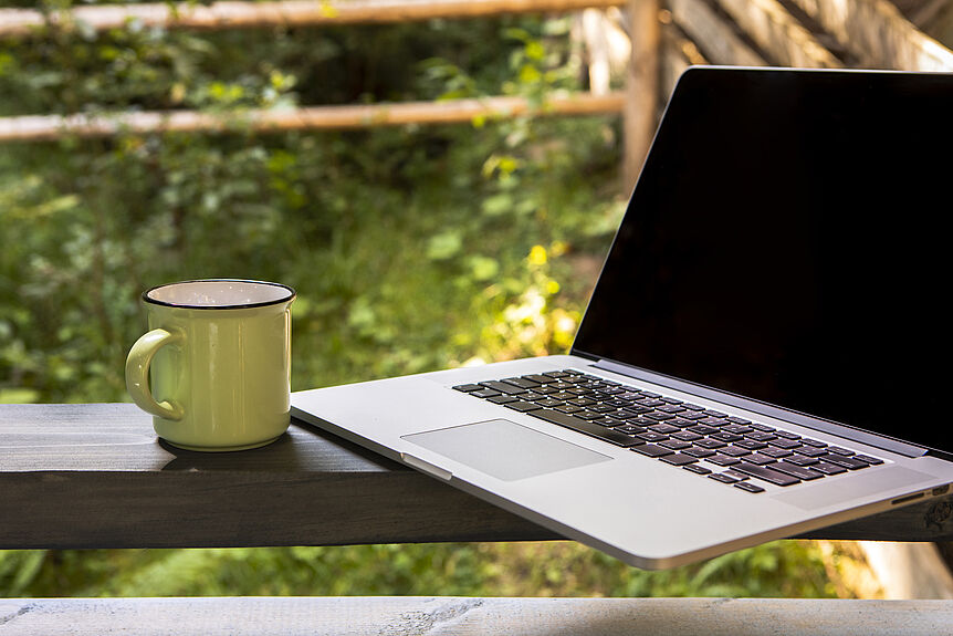 Front view laptop and cup of coffee (Freepik free license)